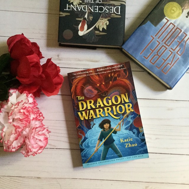 hannahsophialin the dragon warrior books and flowers flatlay